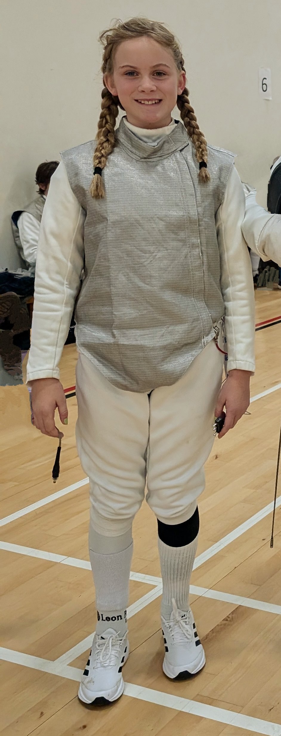 Photo of Gladys in fencing gear