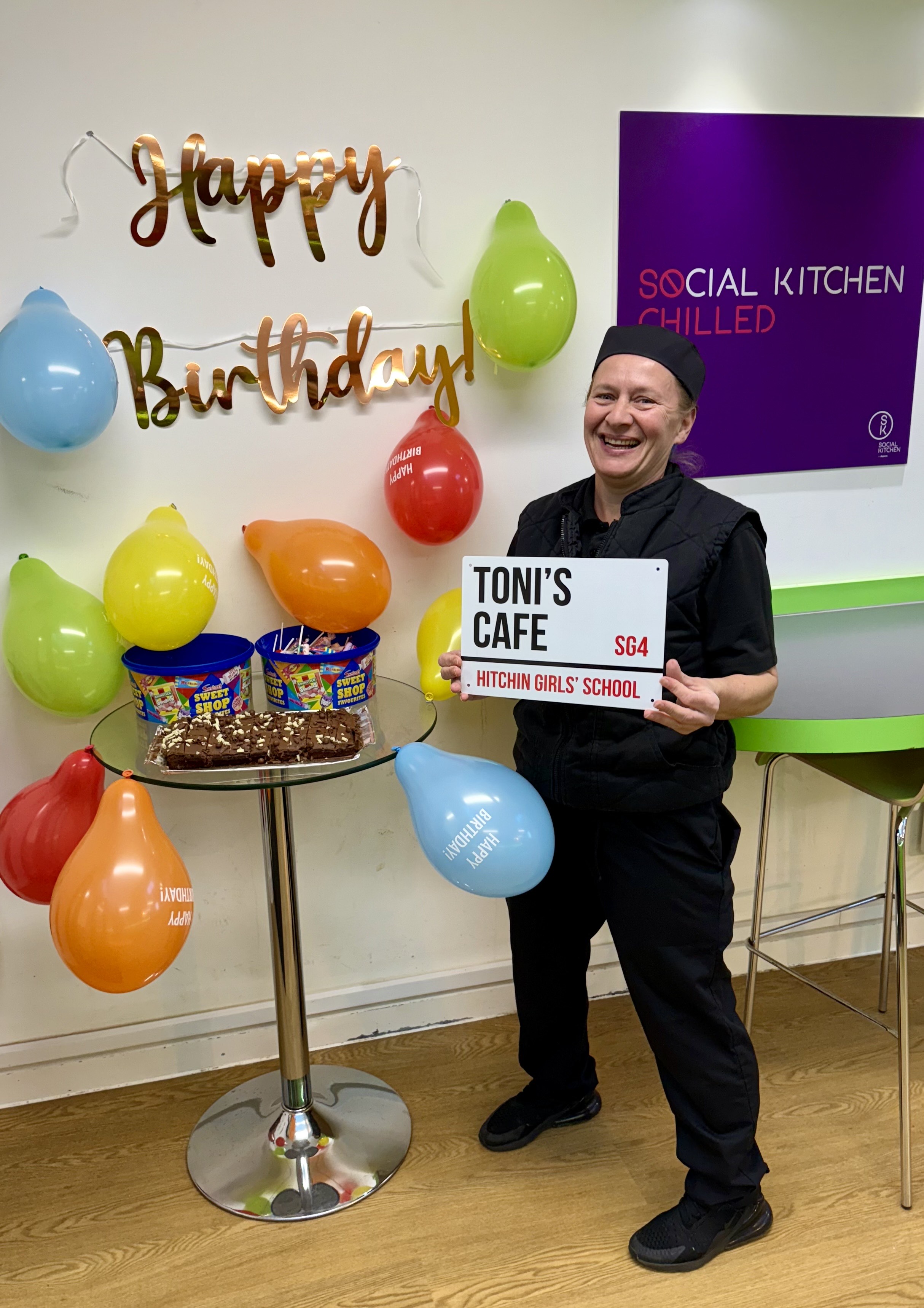 Photo of cafe supervisor Toni and birthday decorations